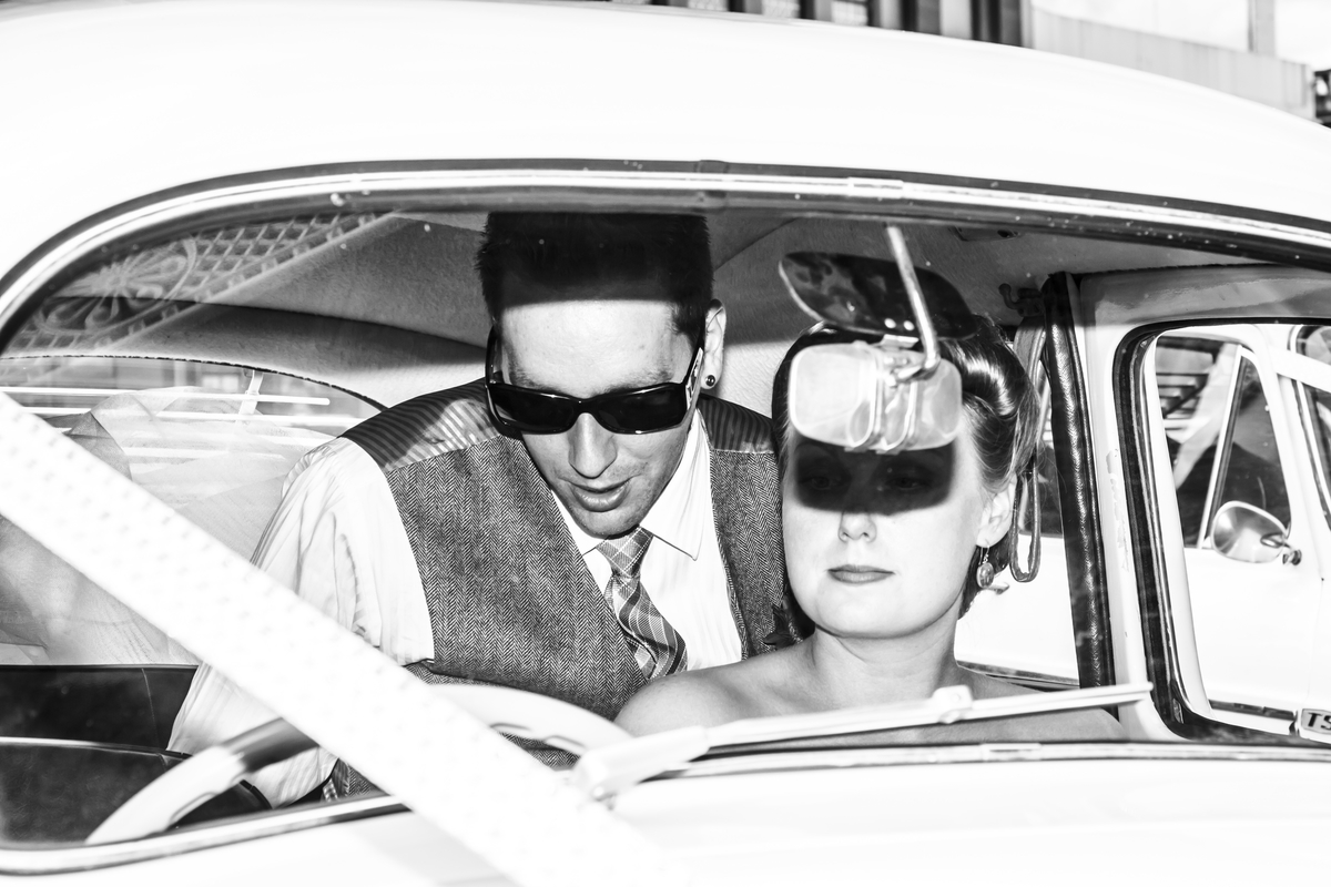 Scene from the 50s Celebrity Couple in a car blinded by a firing camera flash