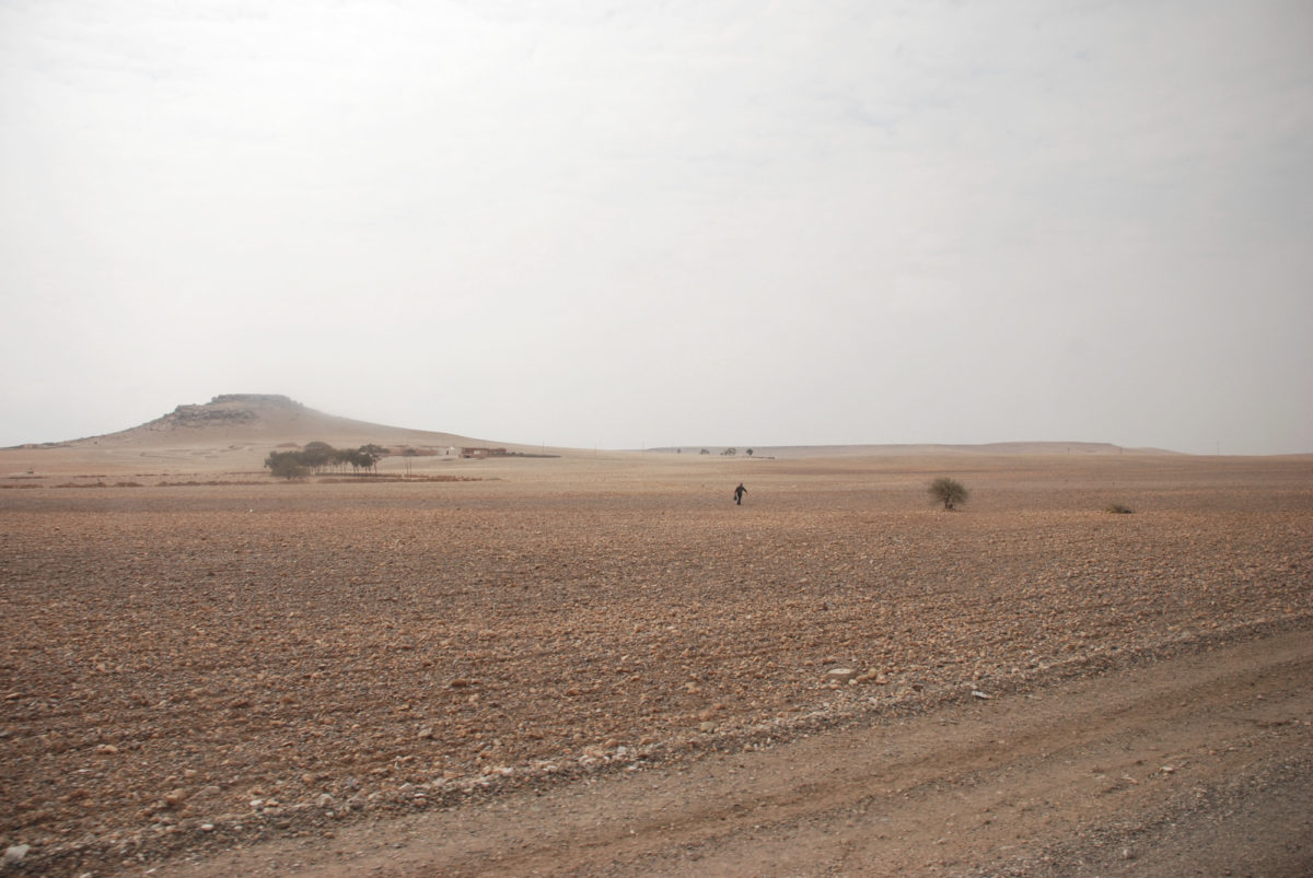 A Man walking through a Moroccan desert Photo: Aldona Kmiec desert landscape